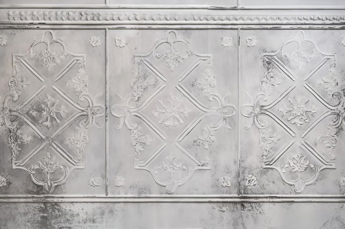 Fototapete Raue graue Wand mit Verzierungen