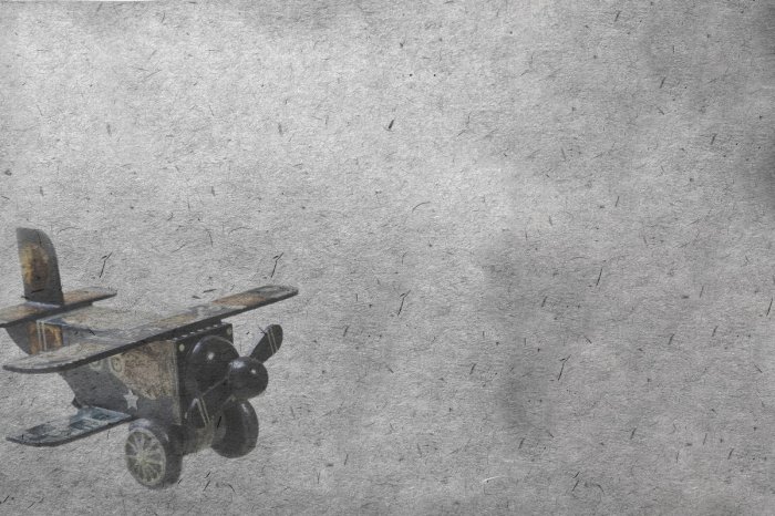 Fototapete Holzflugzeug Spielzeug auf grauem Hintergrund