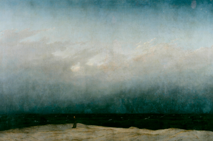 Bild Ein einsamer Wanderer an einem felsigen Meeresufer