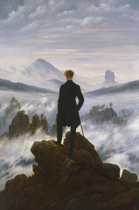 Bild Ein eleganter Mann steht auf einem Felsgipfel