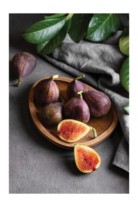 Poster Eine natürliche Komposition aus Feigen und Blättern auf der Küchentheke