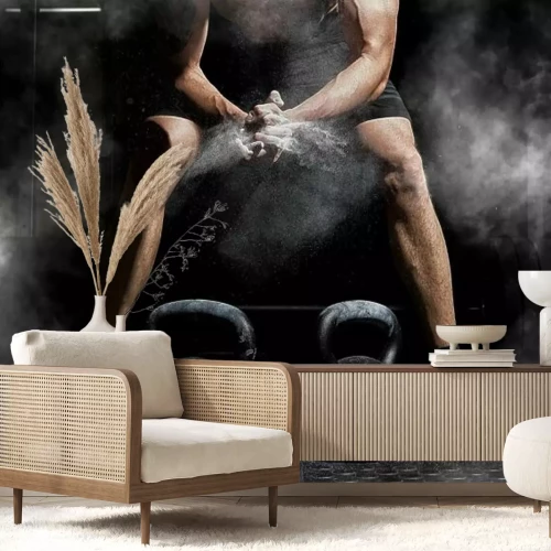 Fototapete Ein Mann bereitet sich darauf vor einen Ball zu heben Gewichtheben