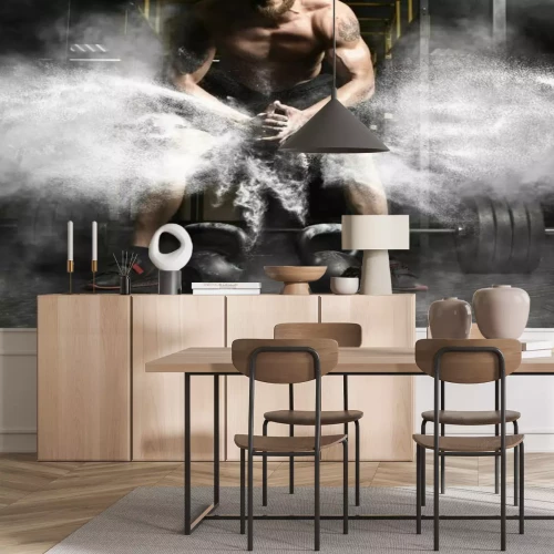 Fototapete Ein Mann im Fitnessstudio mit einer Hantel