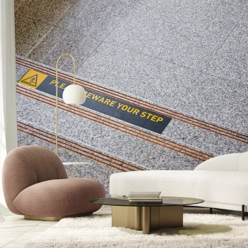 Sticker Please beware your step sticker on polished stone floor close up.