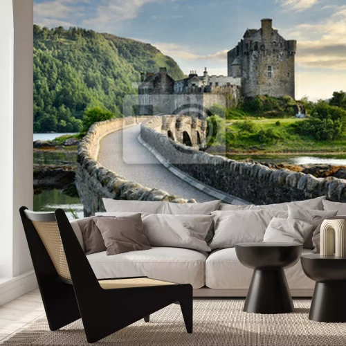 Fototapete Evening light on restored Eilean Donan Castle on Island at three lochs with added stone arch footbridge Scottish Highlands Scotland UK
