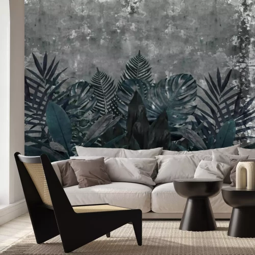 Fototapete Blaue tropische Blätter auf Betonhintergrund