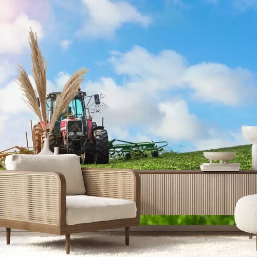 Fototapete Traktor pflügt das Feld vor dem Hintergrund des Himmels