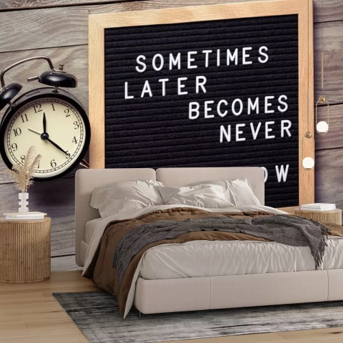 Sticker Inspirational motivational quote Sometimes later becomes never. Do it now words on a letter board on wooden background near vintage alarm clock. Success and motivation concept.