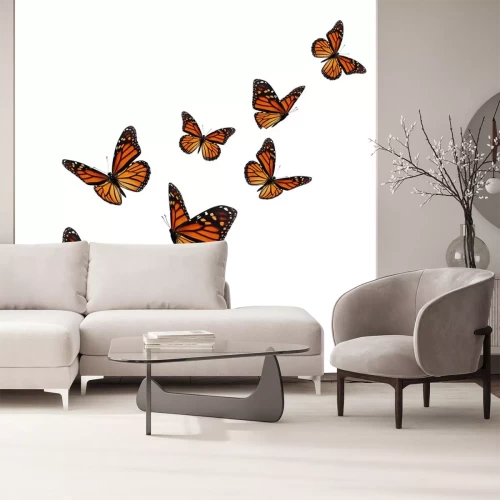 Sticker Orange-schwarze Schmetterlinge in die Luft steigend