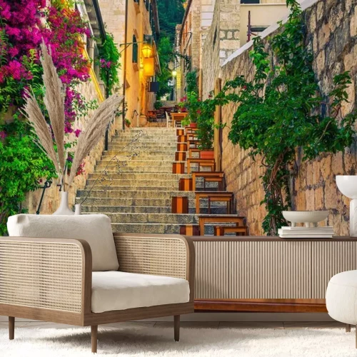 Fototapete Narrow street and street cafe decorated with flowers, Hvar, Croatia