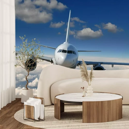 Fototapete Ein Flugzeug über den Wolken