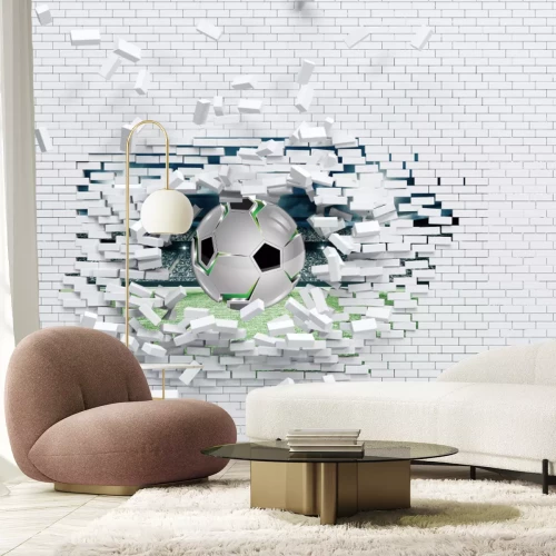 Fototapete Ein Fußball durchbricht eine Ziegelmauer