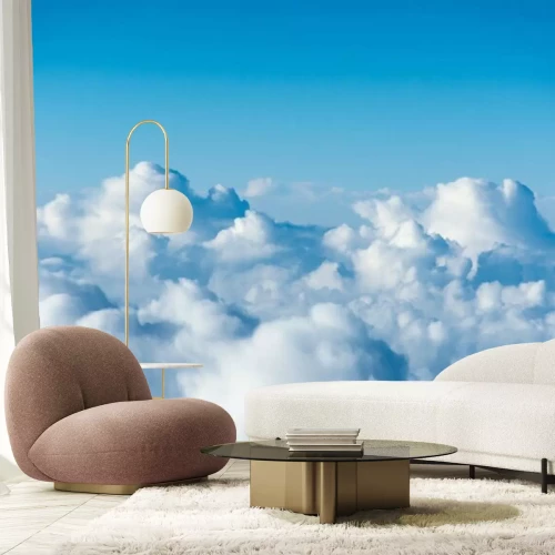 Fototapete Flight over the clouds. view of the clouds from the airplane window