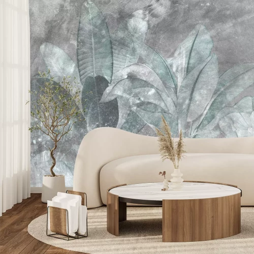 Fototapete Grüne tropische Blätter vor einem Hintergrund aus grauem Beton