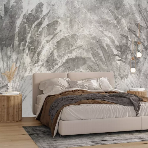 Fototapete Große graue tropische Blätter auf Beton