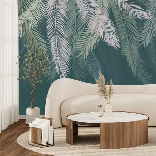 Fototapete Von oben hängende Palmblätter vor grünem Hintergrund