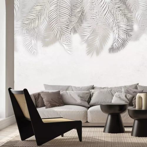 Fototapete Ein zartes Arrangement mit von oben herabhängenden weißen Palmblättern