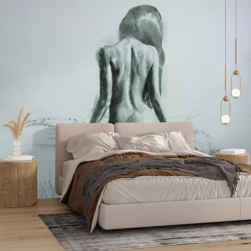 Fototapete Minimalistisches Porträt einer Frau, die auf einem Bett sitzt