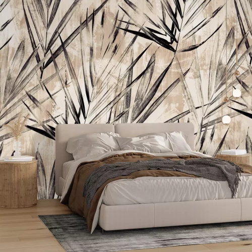 Fototapete Schwarze Palmenblätter an einer beigen Wand