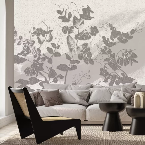 Fototapete Graue Blätter an einer sandfarbenen Wand