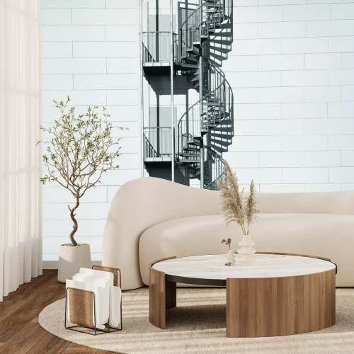 Fototapete Wendeltreppe an einer weißen Backsteinwand