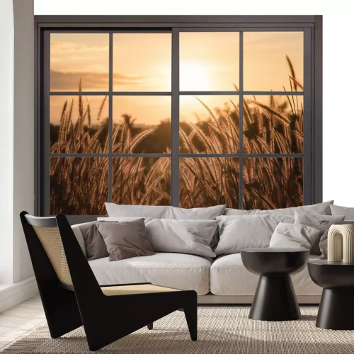 Sticker Blick aus dem Fenster auf den Sonnenuntergang über der Wiese