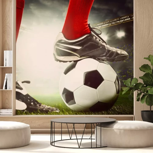 Fototapete Beine des Fußballspielers am Ball