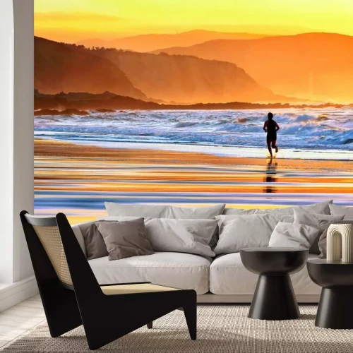 Fototapete Ein Läufer am Strand bei Sonnenuntergang