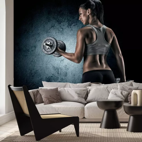 Fototapete Muscular woman in studio on dark background