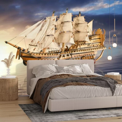 Sticker Ein Segelboot vor dem Hintergrund eines goldenen Sonnenuntergangs