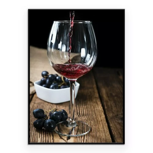 Poster Ein Glas Rotwein auf einem Holztisch