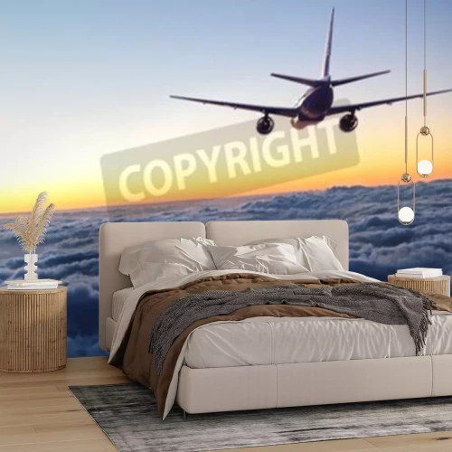 Fototapete In Richtung des Sonnenuntergangs fliegender Flugzeug