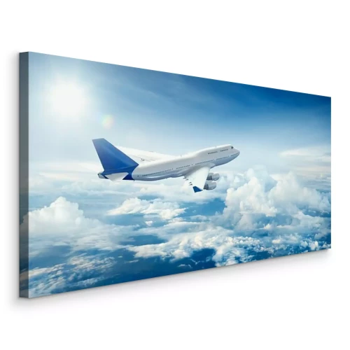 Bild Ein Flugzeug, das über den Wolken fliegt