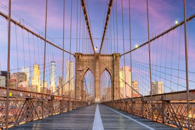 Fototapete New York, New York on the Brooklyn Bridge Promenade facing Manhattan's skyline at dawn.