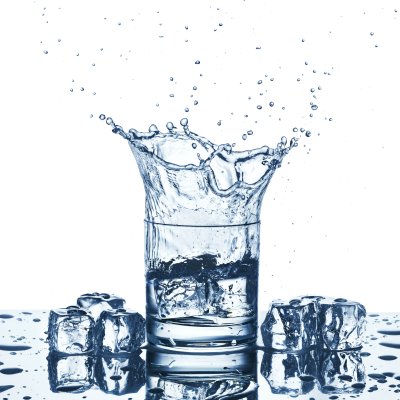 Fototapete Water splash in glass of blue color