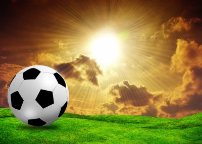 Fototapete Fußball in der untergehenden Sonne
